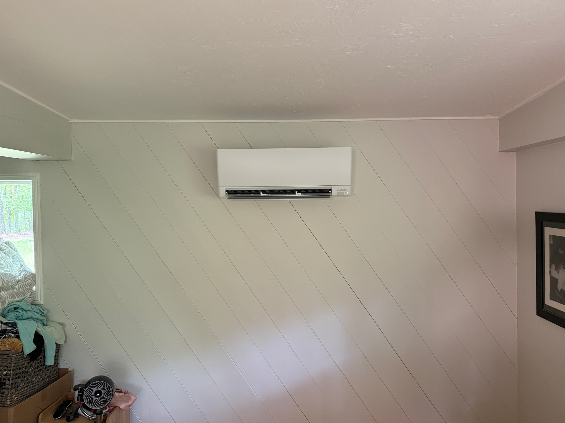 Mitsubishi wall unit mounted high on a painted plank wall
